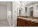 Bathroom with double sinks, tile countertops, and a large mirror at 9417 E Charter Oak Dr, Scottsdale, AZ 85260