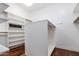 Walk-in closet with custom shelving and hardwood floors provides plenty of storage space at 9417 E Charter Oak Dr, Scottsdale, AZ 85260
