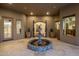 Elegant courtyard featuring a stone fountain centerpiece, setting a welcoming tone for the home's entry at 9417 E Charter Oak Dr, Scottsdale, AZ 85260