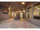 Spacious courtyard showcasing a decorative fountain, with views into the home through large windows at 9417 E Charter Oak Dr, Scottsdale, AZ 85260
