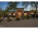 Inviting home exterior with desert landscaping, stone accents and a welcoming front entrance at 9417 E Charter Oak Dr, Scottsdale, AZ 85260
