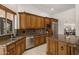 Gourmet kitchen featuring custom wood cabinets, granite countertops, and stainless steel appliances at 9417 E Charter Oak Dr, Scottsdale, AZ 85260