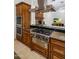 Modern kitchen with stainless steel range hood, cooktop, and custom cabinetry, perfect for cooking at 9417 E Charter Oak Dr, Scottsdale, AZ 85260
