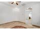 Living room with tile flooring, ceiling fan, and neutral paint, leading to an adjacent space, creating an open flow at 9417 E Charter Oak Dr, Scottsdale, AZ 85260