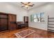 Office featuring hardwood floors, built in cabinets, a ceiling fan and large window at 9417 E Charter Oak Dr, Scottsdale, AZ 85260