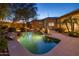 Backyard pool with waterfalls and lush landscaping, creating a private oasis for relaxation and enjoyment at 9417 E Charter Oak Dr, Scottsdale, AZ 85260