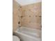 Bathroom features a shower with a tub, decorative tile and a shower head at 9417 E Charter Oak Dr, Scottsdale, AZ 85260