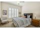 Inviting bedroom featuring shuttered windows, a ceiling fan, and a comfortable bed with stylish accents at 9540 N 114Th Way, Scottsdale, AZ 85259