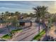 Aerial view of a gated community entrance with lush landscaping and palm trees, offering security and curb appeal at 9540 N 114Th Way, Scottsdale, AZ 85259