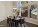 Elegant dining room featuring a large window with backyard views and modern chandelier above the table at 9540 N 114Th Way, Scottsdale, AZ 85259