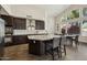 Well-lit kitchen featuring stainless steel appliances, granite countertops, and a large island with barstool seating at 9540 N 114Th Way, Scottsdale, AZ 85259
