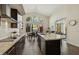 Bright kitchen with granite countertops, stainless appliances, dark cabinetry, and backyard view at 9540 N 114Th Way, Scottsdale, AZ 85259