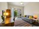 Bright living room with a large desk and sofa, leading to a private outdoor area at 9540 N 114Th Way, Scottsdale, AZ 85259