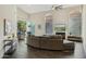 Open living room boasts vaulted ceilings, wood flooring, fireplace, and a view of the patio at 9540 N 114Th Way, Scottsdale, AZ 85259