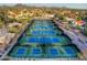 Aerial shot showcasing multiple well-maintained tennis courts surrounded by homes and desert landscape at 9540 N 114Th Way, Scottsdale, AZ 85259