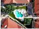 Overhead shot of a community pool surrounded by landscaped grounds and residential buildings with red-tiled roofs at 9708 E Via Linda -- # 1338, Scottsdale, AZ 85258