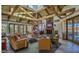 Spacious clubhouse interior featuring exposed wood beams, a stone fireplace, and comfortable seating arrangements at 9708 E Via Linda -- # 1338, Scottsdale, AZ 85258