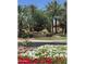 The Racquet Club community entrance features lush landscaping, mature palm trees and stone signage at 9708 E Via Linda -- # 1338, Scottsdale, AZ 85258