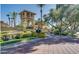 Community entrance with a guard tower, lush landscaping, and paved driveway and sidewalk at 9708 E Via Linda -- # 1338, Scottsdale, AZ 85258