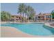 Large community pool with lounge chairs, palm trees, and nearby residential buildings at 9708 E Via Linda -- # 1338, Scottsdale, AZ 85258