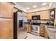 The kitchen features stainless steel appliances, granite countertops, and wood cabinets at 9708 E Via Linda -- # 1338, Scottsdale, AZ 85258