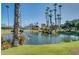 Scenic pond view with lush landscaping, palm trees, and a fountain in a tranquil community setting at 9708 E Via Linda -- # 1338, Scottsdale, AZ 85258