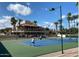 Action shot on a tennis court, with players, spectators, and a clubhouse in the background at 9708 E Via Linda -- # 1338, Scottsdale, AZ 85258