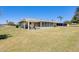Charming sunroom addition with a pergola-covered patio and a spacious, well-maintained backyard at 9805 W Burns Dr, Sun City, AZ 85351