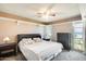 Bright bedroom with a ceiling fan, carpet, and natural light from a large window at 9805 W Burns Dr, Sun City, AZ 85351
