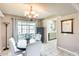 Dining room with elegant chandelier and access to an enclosed patio at 9805 W Burns Dr, Sun City, AZ 85351
