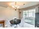 Cozy dining room with a modern chandelier and access to patio at 9805 W Burns Dr, Sun City, AZ 85351