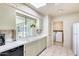 Bright kitchen space with lots of natural light, brick walls, tiled flooring and plenty of counter space at 9805 W Burns Dr, Sun City, AZ 85351