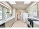 Bright kitchen features tile floor, white appliances, and lots of storage at 9805 W Burns Dr, Sun City, AZ 85351