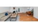 Open-concept living room featuring a whitewashed fireplace, wood floors and a staircase at 1826 E Frier Dr # 2, Phoenix, AZ 85020