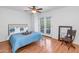 Bright main bedroom includes wood floors and balcony access with view of the neighborhood at 1826 E Frier Dr # 2, Phoenix, AZ 85020