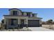 View of the home featuring neutral colors, a covered porch, and a two-car garage with a desert landscape at 19117 W Missouri Ave, Litchfield Park, AZ 85340