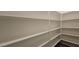 A walk-in pantry featuring adjustable shelves, providing ample storage for all your culinary needs at 19117 W Missouri Ave, Litchfield Park, AZ 85340