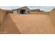 Large, dirt backyard with a block wall fence at 2680 E Santa Rosalia Dr, Casa Grande, AZ 85194