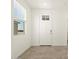 Inviting entryway with tile flooring, a window letting in natural light, and a white front door at 2680 E Santa Rosalia Dr, Casa Grande, AZ 85194