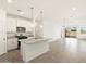 Modern kitchen with white cabinetry, stainless steel appliances, a granite island, and an open floor plan at 2680 E Santa Rosalia Dr, Casa Grande, AZ 85194
