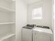 Laundry room equipped with washer, dryer, and storage shelves at 2680 E Santa Rosalia Dr, Casa Grande, AZ 85194