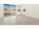 Light-filled living room featuring neutral tile flooring, a sliding glass door, and window views at 2680 E Santa Rosalia Dr, Casa Grande, AZ 85194