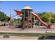 Community playground with slides, climbing structures, and shade coverings for a fun and safe play area at 2680 E Santa Rosalia Dr, Casa Grande, AZ 85194