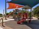 A colorful playground with multiple slides and play structures designed for active fun and social interaction at 2680 E Santa Rosalia Dr, Casa Grande, AZ 85194
