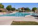 Resort-style pool area with sun loungers and various water features for relaxation and recreation at 2680 E Santa Rosalia Dr, Casa Grande, AZ 85194