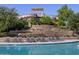 Community pool featuring a slide and lounge chairs, surrounded by professionally landscaped grounds at 2680 E Santa Rosalia Dr, Casa Grande, AZ 85194