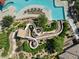 Aerial close up of community water park slide with pristine landscaping and sun loungers at 2680 E Santa Rosalia Dr, Casa Grande, AZ 85194