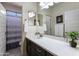 Well-lit bathroom with dual vanity, dark cabinets, and updated fixtures at 2903 E Quenton St, Mesa, AZ 85213