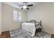 Bright bedroom features neutral walls and modern fan, and shuttered window at 2903 E Quenton St, Mesa, AZ 85213