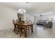 Cozy dining room open to the living room with chandelier and wood dining set at 2903 E Quenton St, Mesa, AZ 85213
